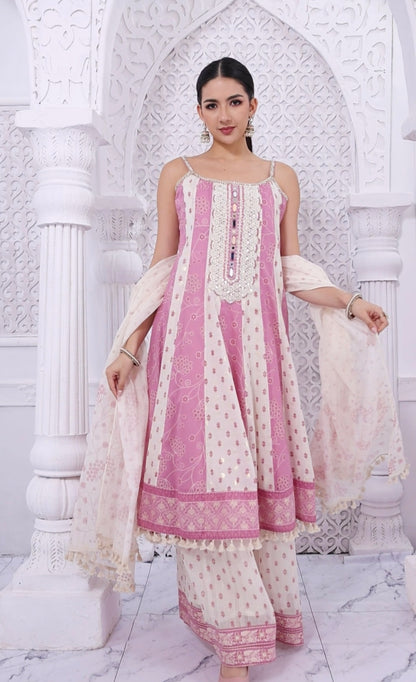 Woman wearing a pink and white traditional outfit in a decorative setting